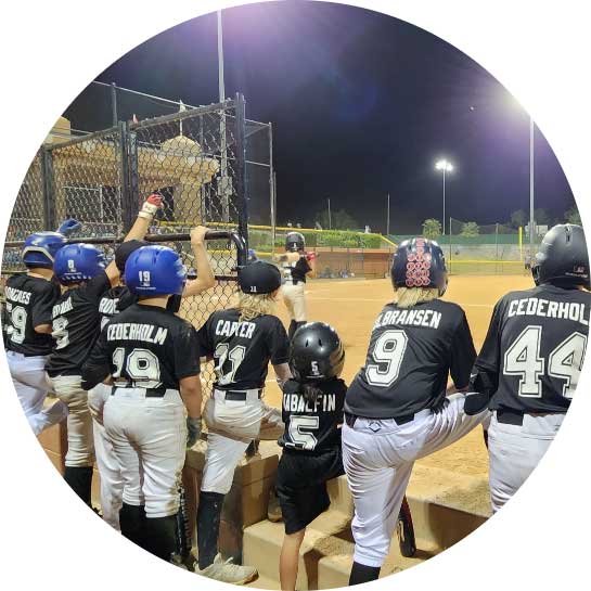 Youth baseball team watching game from dugout